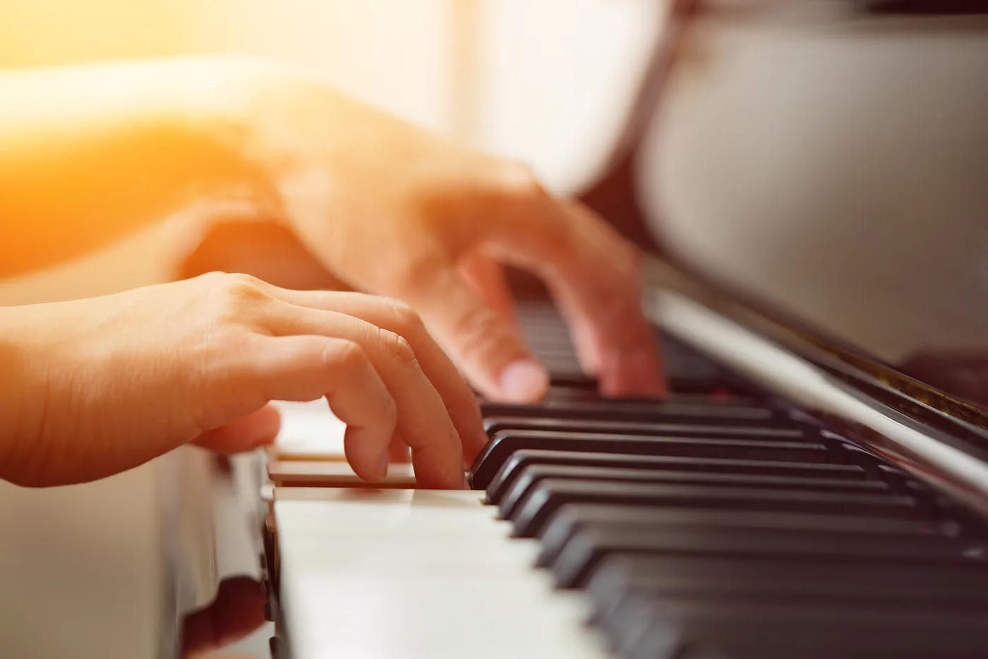 Clase de música: manos sobre el teclado de un piano